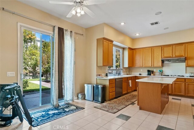 kitchen with a kitchen island, ceiling fan, stainless steel dishwasher, and light tile patterned flooring