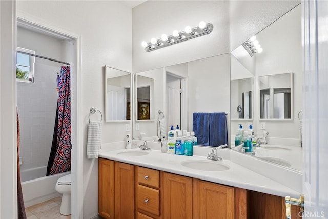 full bathroom featuring tile patterned flooring, shower / tub combo with curtain, vanity, and toilet