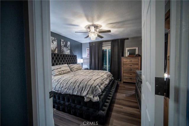 bedroom with ceiling fan and dark hardwood / wood-style flooring