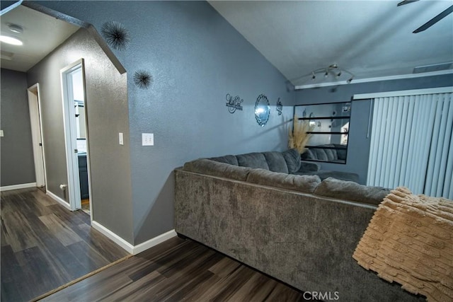 living room with dark hardwood / wood-style flooring and vaulted ceiling