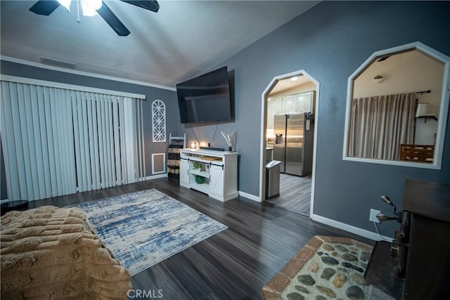 living room featuring vaulted ceiling, ceiling fan, and dark hardwood / wood-style floors