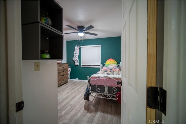 bedroom with ceiling fan and wood-type flooring