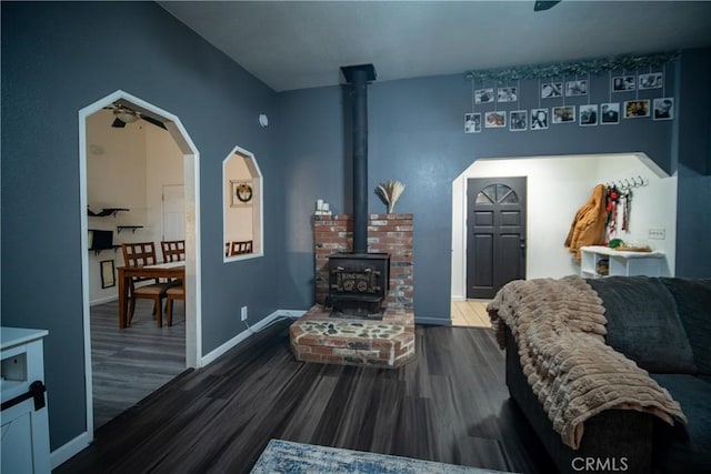 living room with a wood stove and hardwood / wood-style floors