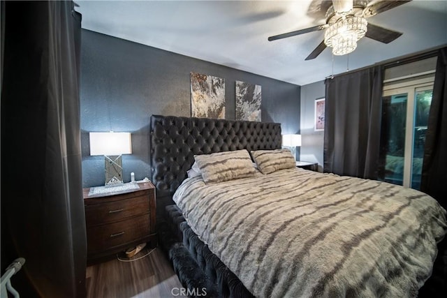 bedroom with ceiling fan, wood-type flooring, and access to outside