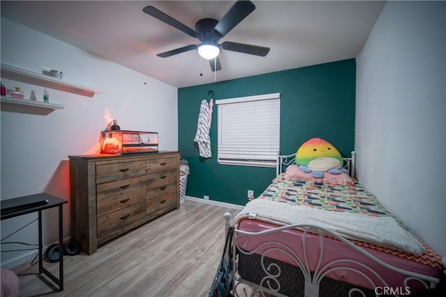 bedroom with light hardwood / wood-style floors and ceiling fan