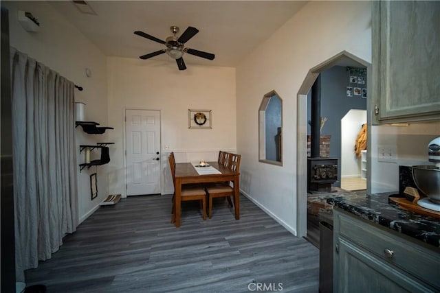 dining space featuring ceiling fan and dark wood-type flooring