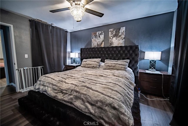 bedroom featuring ceiling fan and dark hardwood / wood-style floors