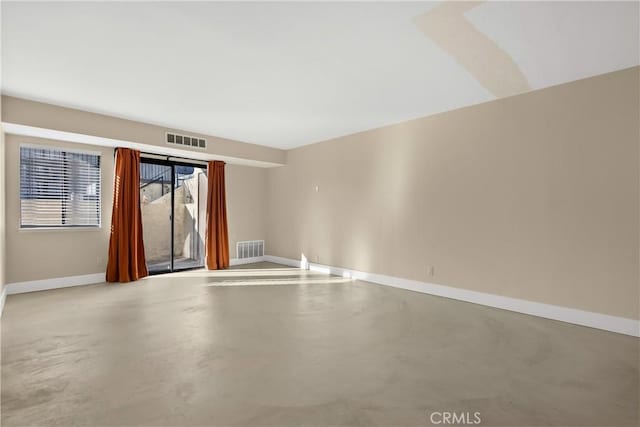 spare room featuring concrete flooring