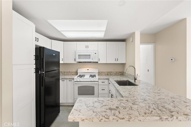 kitchen with white appliances, sink, white cabinetry, light stone counters, and kitchen peninsula