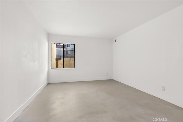 spare room with concrete floors
