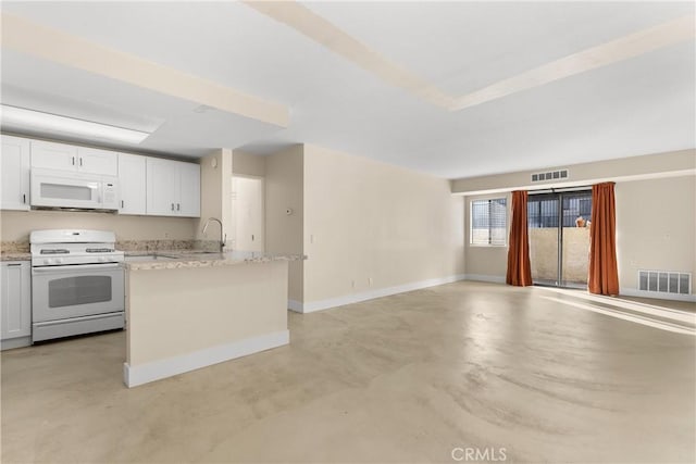 kitchen with sink, a kitchen island, light stone counters, white appliances, and white cabinets