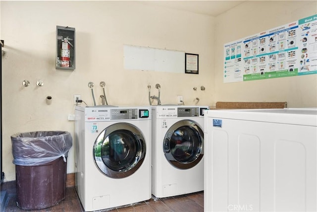 clothes washing area featuring washer and dryer and dark hardwood / wood-style floors