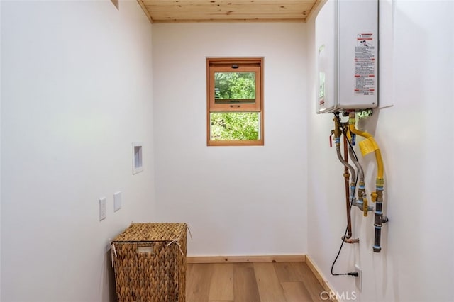 washroom with hardwood / wood-style floors and wood ceiling