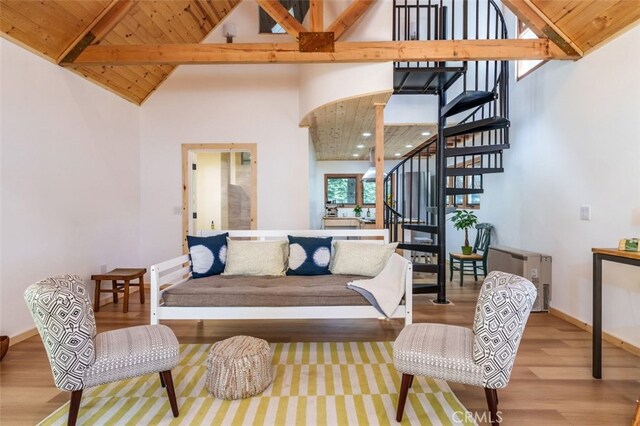 living room featuring beamed ceiling, high vaulted ceiling, wood ceiling, and wood-type flooring