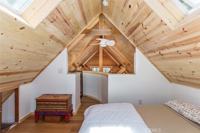 bedroom with vaulted ceiling with skylight, wood ceiling, and hardwood / wood-style flooring