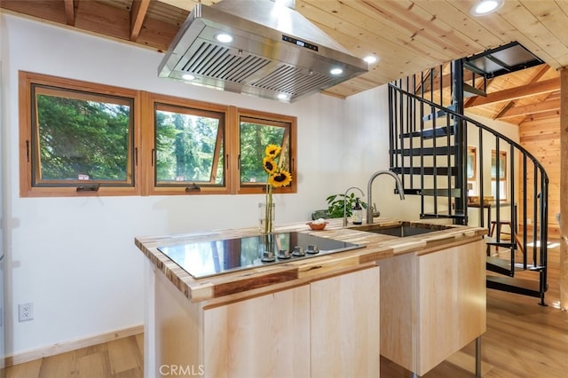 kitchen featuring a center island with sink, island range hood, wooden ceiling, and sink