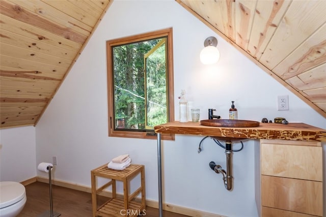 bathroom with hardwood / wood-style floors, toilet, wood ceiling, and vaulted ceiling