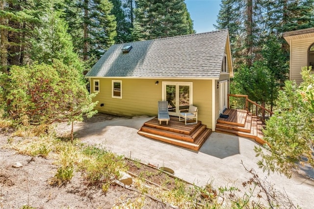 rear view of house with french doors and a deck