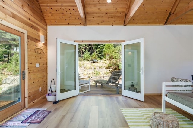 entryway featuring french doors, wooden walls, vaulted ceiling with beams, light wood-type flooring, and wood ceiling