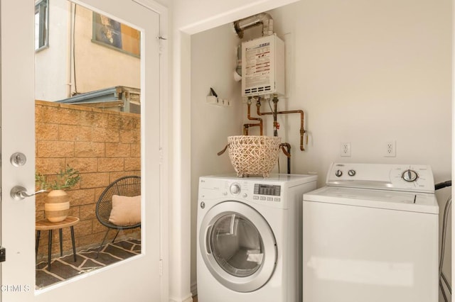 laundry area with washing machine and dryer and tankless water heater