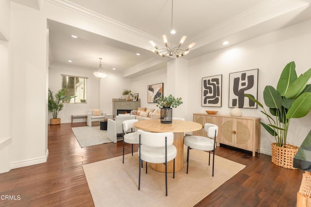 dining room featuring an inviting chandelier, crown molding, and dark wood-type flooring