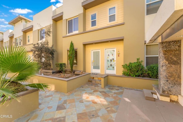 entrance to property with a patio