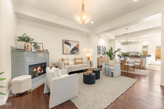 living room featuring a fireplace, dark hardwood / wood-style floors, and ornamental molding