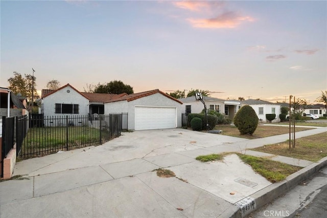 ranch-style home featuring a garage and a yard