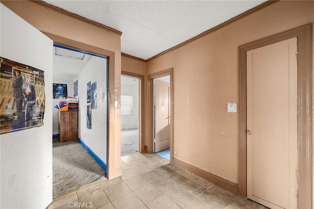 hallway featuring crown molding, light carpet, and a textured ceiling