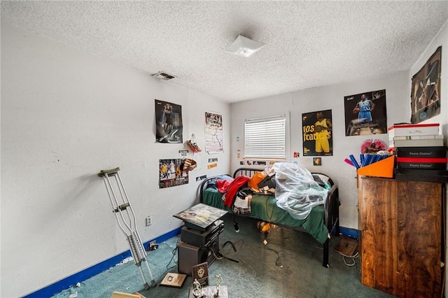 bedroom with carpet floors and a textured ceiling