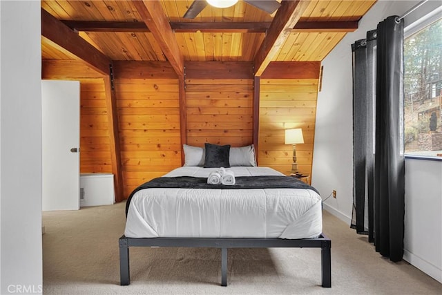 bedroom featuring wood walls, beamed ceiling, wood ceiling, and light colored carpet