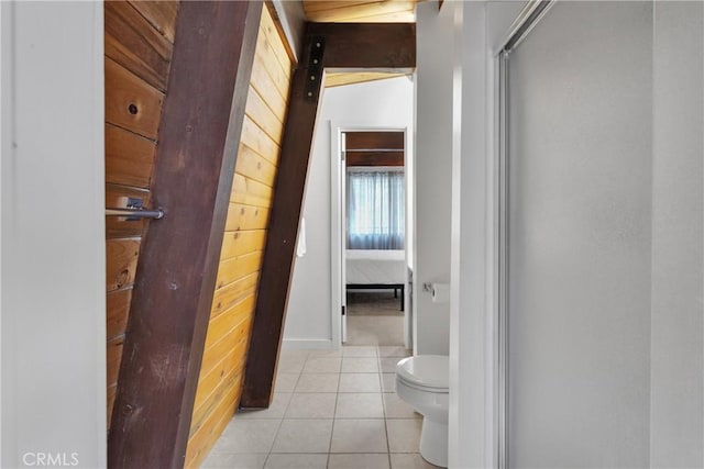 bathroom with tile patterned floors, toilet, and walk in shower