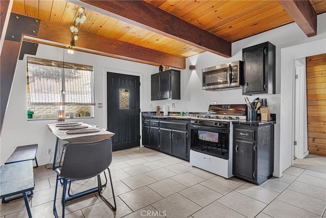 kitchen with light tile patterned floors, wooden ceiling, white gas stove, and beam ceiling