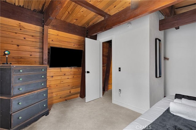 bedroom with beam ceiling, wooden ceiling, and light colored carpet