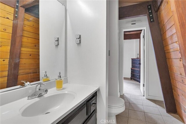 bathroom featuring toilet, vanity, and tile patterned floors