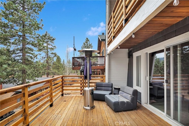 wooden terrace with outdoor lounge area