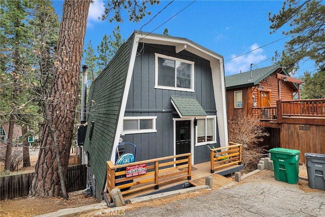 back of property featuring a wooden deck