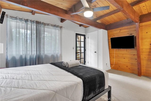 carpeted bedroom with beamed ceiling, ceiling fan, wooden walls, and wood ceiling