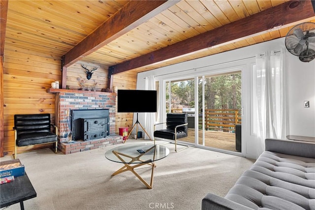 living room with carpet floors, a wood stove, beamed ceiling, and wood ceiling