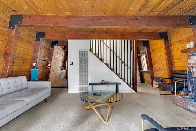 living room with carpet flooring, beam ceiling, wooden walls, and wood ceiling