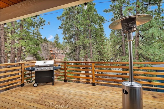 wooden terrace featuring a grill