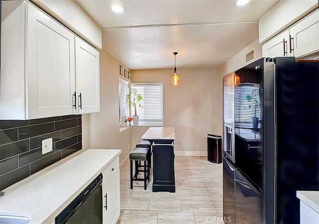 kitchen with backsplash, hanging light fixtures, stainless steel dishwasher, black fridge with ice dispenser, and white cabinetry