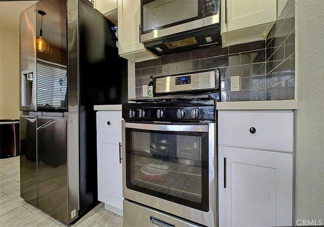 kitchen with tasteful backsplash, white cabinetry, and stainless steel appliances