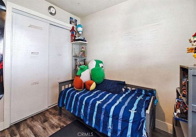 bedroom with dark hardwood / wood-style flooring