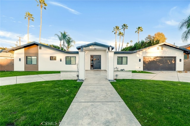 view of front of property featuring a garage and a front yard