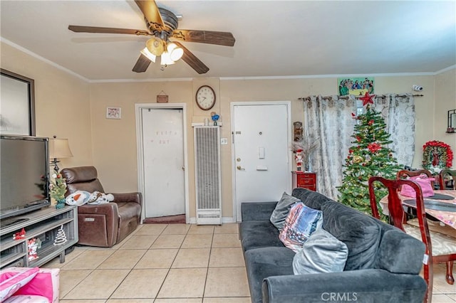 tiled living room featuring crown molding and ceiling fan