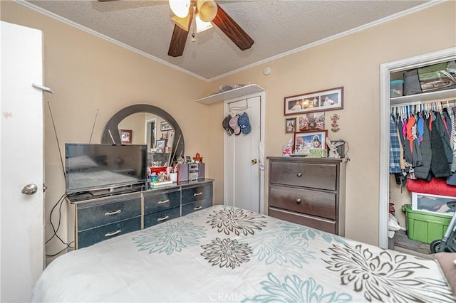 bedroom with a textured ceiling, a closet, ceiling fan, and ornamental molding