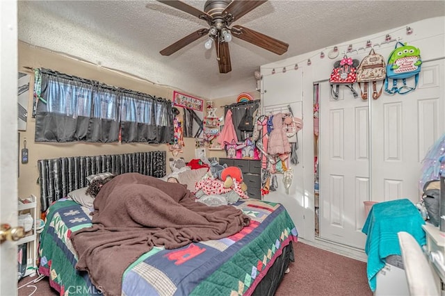 carpeted bedroom featuring ceiling fan and a textured ceiling