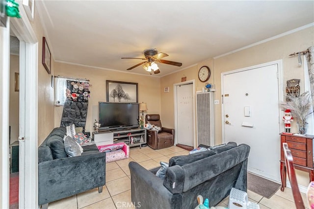 living room with light tile patterned floors, ceiling fan, and ornamental molding