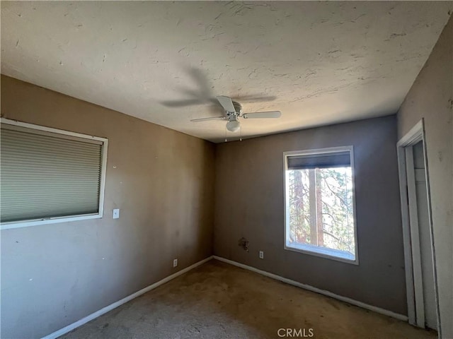 empty room with ceiling fan and carpet floors